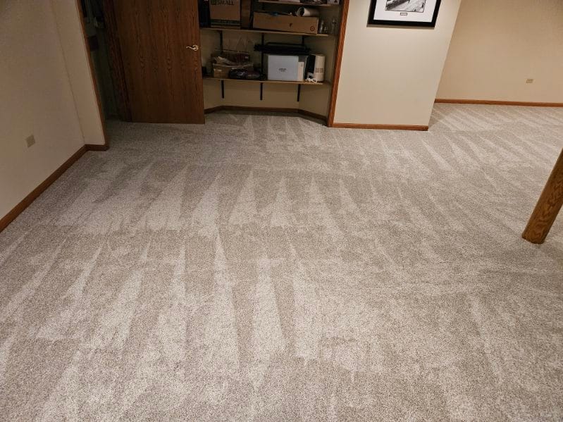 Freshly installed plush carpet in New Lenox basement, creating a cozy and clean foundation for a multi-use living area