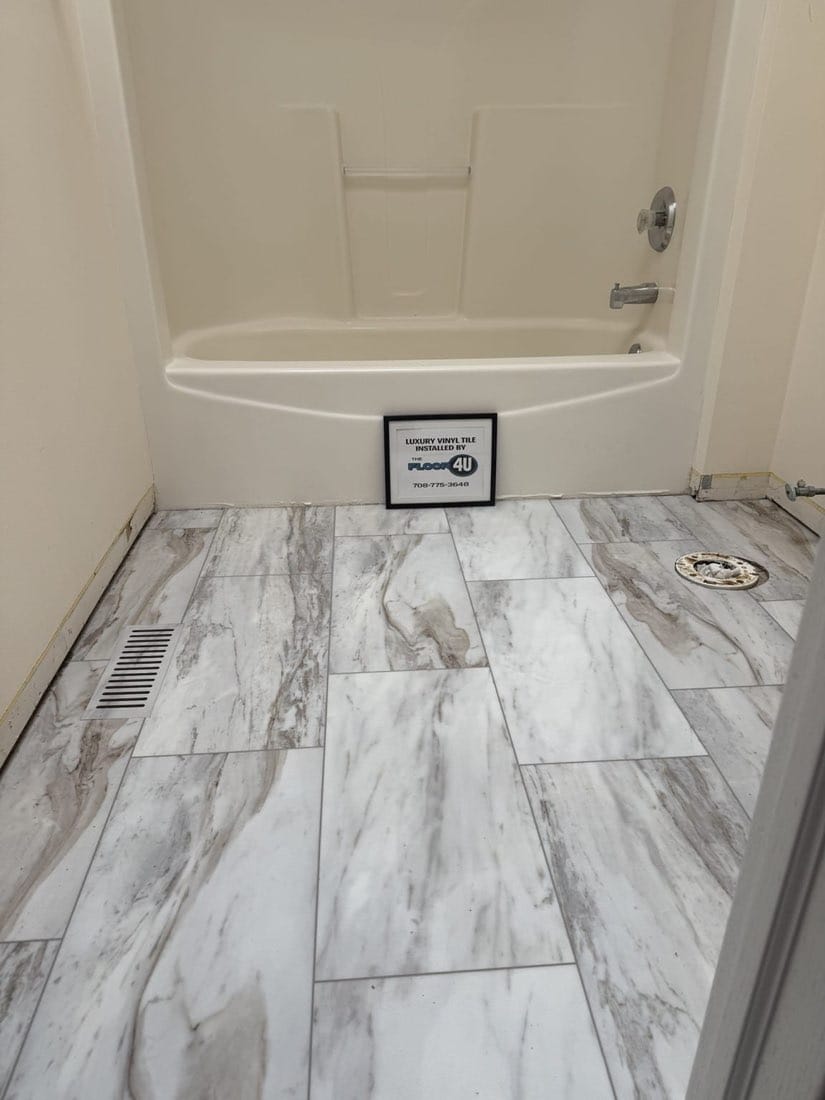 Waterproof COREtec Sonia Marble luxury vinyl plank flooring around a tub