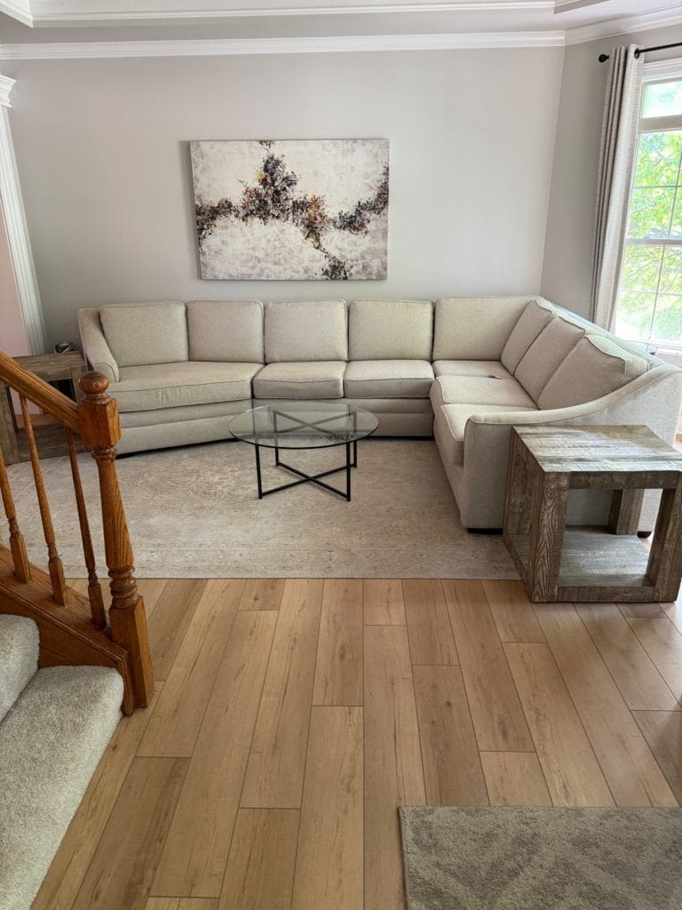Living room with luxury vinyl plank flooring and sectional sofa installed by The Floor 4 U in Mokena, IL. Luxury vinyl plank installation Naperville IL
