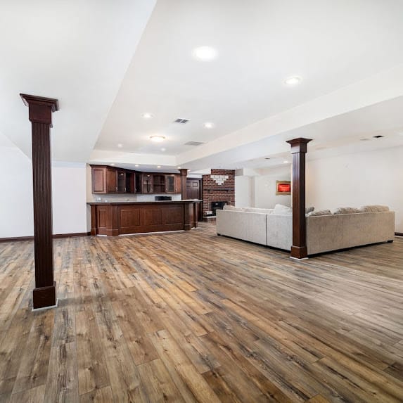 Luxury vinyl plank flooring installed in a finished Orland Park, IL basement by The Floor 4 U. Spacious and multi-use design.