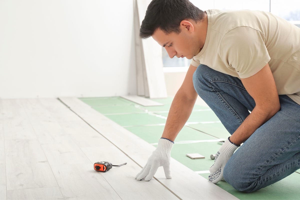 Laminate plank flooring installation shown for comparison with luxury vinyl plank lifespan