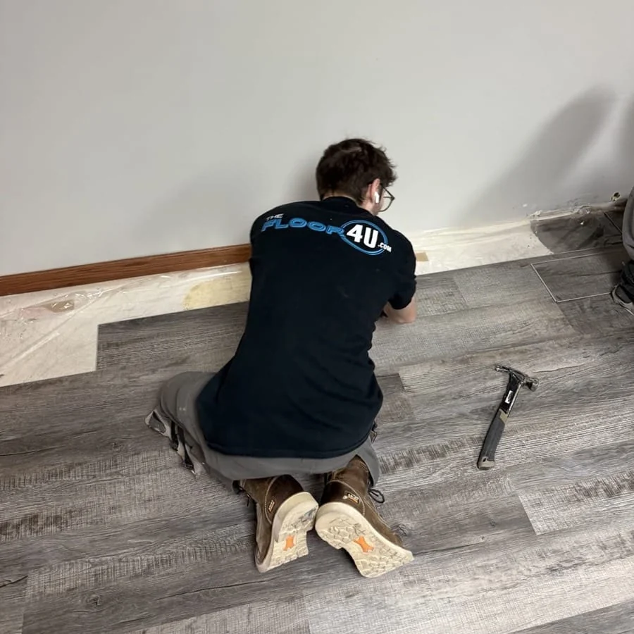 The Floor 4U installer fitting click-together luxury vinyl plank flooring in a Mokena area home