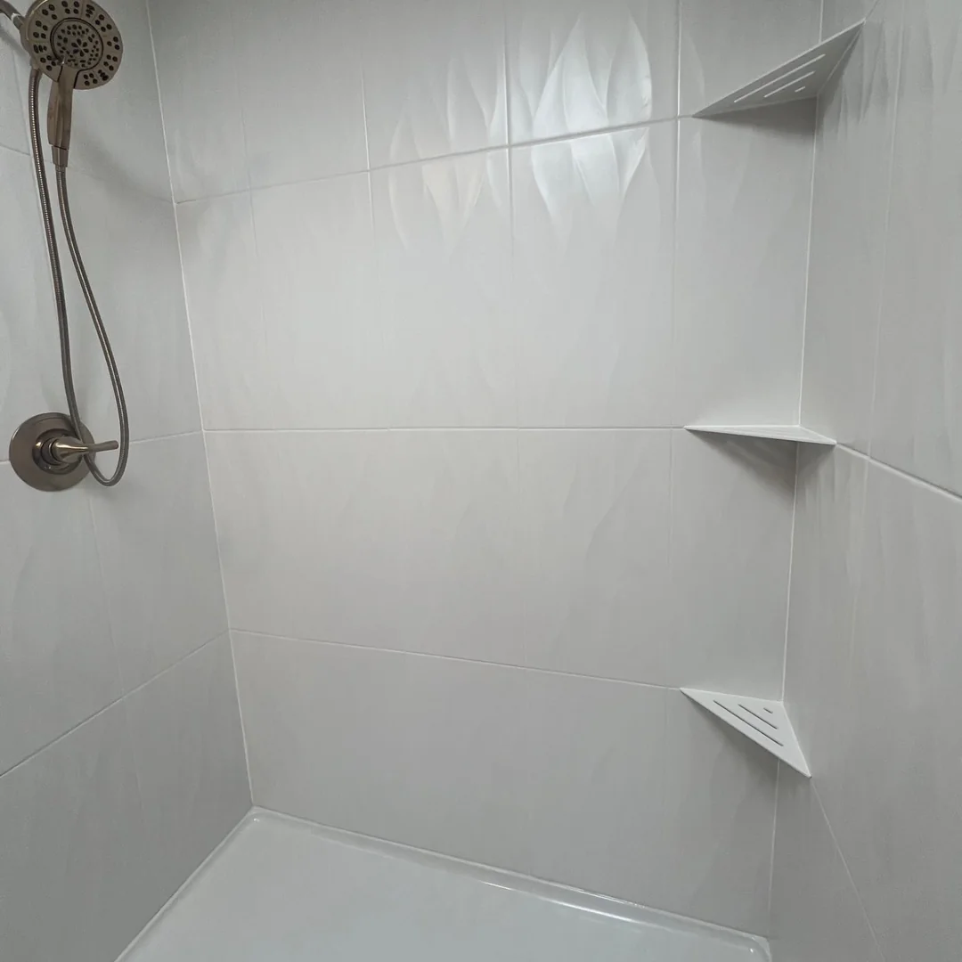 White textured shower wall tile with sealed grout lines and corner shelves installed by The Floor 4U in Joliet, IL